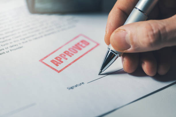 Approved document with a hand signing on the line